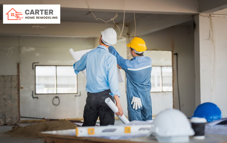 Engineer and worker discussing home renovation plans for a general remodeling service.