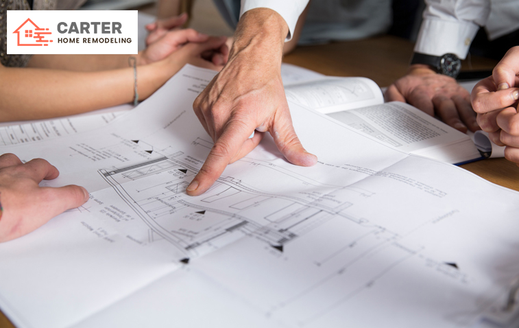Group discussing over ADU layout plan on the desk