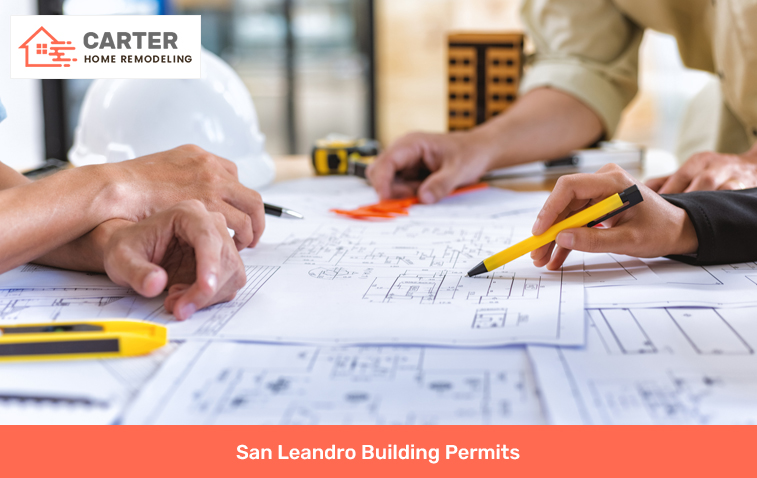Two people discussing building permit requirements with plans on a desk.